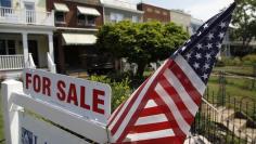 FILE PHOTO: A U.S. flag decorates a for-sale sign at a home in the Capitol Hill neighborhood of Washington, August 21, 2012. REUTERS/Jonathan Ernst/Files