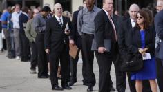 People wait in line to enter the Nassau County Mega Job Fair at Nassau Veterans Memorial Coliseum in Uniondale, New York October 7, 2014. REUTERS/Shannon Stapleton