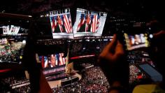 Republican presidential nominee Donald Trump is seen on video monitors as people take photographs during the Republican National Convention in Cleveland, Ohio