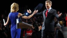 Senator Rand Paul walks to embrace his wife Kelley before formally announcing his candidacy for president during an event in Louisville, Kentucky, April 7, 2015.  REUTERS/Aaron P. Bernstein