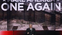 FILE PHOTO: Maricopa County, Arizona, Sheriff Joe Arpaio speaks in front of an image of a border fence during the last day of the Republican National Convention in Cleveland, Ohio, U.S. July 21, 2016. REUTERS/Mike Segar