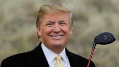 U.S. property mogul Donald Trump holds a golf club during a media event on the sand dunes of the Menie estate, the site for Trump's proposed golf resort, near Aberdeen, Scotland, Britain May 27, 2010.  REUTERS/David Moir/File Photo