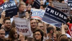 File photo of a protester standing surrounded by supporters of Republican U.S. presidential candidate Donald Trump as he speaks at a campaign rally in Cleveland