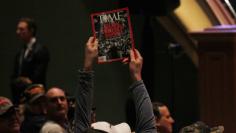 FILE PHOTO - A supporter holds up a copy of Time Magazine with the cover headline "How Trump Won" during Trump's speech at a veteran's rally in Des Moines, Iowa January 28, 2016. REUTERS/Rick Wilking 