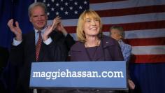 Democratic New Hampshire Governor Maggie Hassan celebrates her re-election with her husband Tom (L) at her side at her election night rally in Manchester, New Hampshire November 4, 2014.  REUTERS/Brian Snyder 