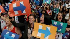 Delegates celebrate after Democratic presidential candidate Hillary Clinton won the Democratic presidential nomination at the Democratic National Convention in Philadelphia, Pennsylvania, U.S., July 26, 2016. REUTERS/Jim Young