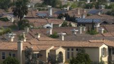 Solar panels are pictured on the rooftops of residential homes in San Diego, California August 21, 2015.   REUTERS/Mike Blake 