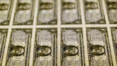 United States one dollar bills are seen on a light table at the Bureau of Engraving and Printing in Washington November 14, 2014.    REUTERS/Gary Cameron/File Photo    