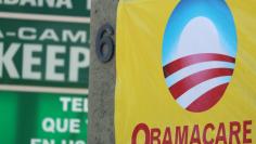 FILE PHOTO: A sign on an insurance store advertises Obamacare in San Ysidro, San Diego, California, U.S., October 26, 2017. REUTERS/Mike Blake/File Photo