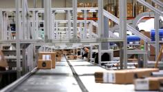 An employee pushes a box on a conveyor belt at the Newegg warehouse on Cyber Monday in City of Industry, California, U.S. November 28, 2016.  REUTERS/Mario Anzuoni