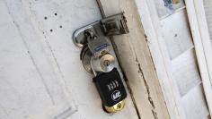 Locks are seen on the front door of an empty abandoned home in East Orange, New Jersey, March 25, 2015. REUTERS/Mike Segar