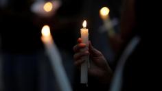 Deferred Action for Childhood Arrivals (DACA) program recipients hold a candle vigil at the San Jacinto Plaza in El Paso