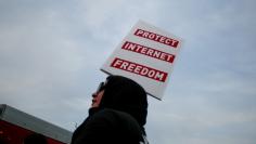 A supporter of Net Neutrality, Lance Brown Eyes, protests the FCC's recent decision to repeal the program in Los Angeles, California, November 28, 2017. REUTERS/ Kyle Grillot