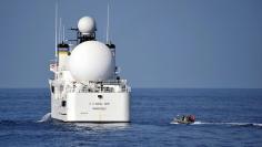 File photo: U.S. sailors in a rigid-hull inflatable boat approach the Military Sealift Command missile range instrumentation ship USNS Invincible (L) to conduct a personnel transfer in Arabian Sea on November 21, 2012.  Courtesy Deven B. King/U.S. Navy/Ha