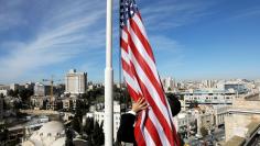 Employee of the King David Hotel raises the U.S. flag ahead of Pence visit in Jerusalem