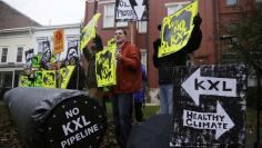 Climate advocates and representatives from the Rosebud Sioux Tribe in South Dakota protest against the Keystone XL pipeline in front of the home (center) of U.S. Senator Mary Landrieu (D-LA), chair of the Senate Energy Committee, in Washington November 17