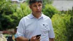 FILE PHOTO: Anthony Noto, chief financial officer of Twitter, holds his phone during the first day of the annual Allen and Co. media conference in Sun Valley, Idaho July 8, 2015.  REUTERS/Mike Blake