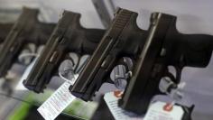 Handguns are seen for sale in a display case at Metro Shooting Supplies in Bridgeton, Missouri, November 13, 2014. REUTERS/Jim Young
