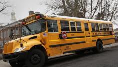 A school bus is seen parked in front of a school in the Queens borough of New York January 15, 2013. REUTERS/Shannon Stapleton 