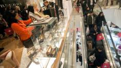 FILE PHOTO: Shoppers look over shoes on sale at a Macy's store in New York, NY, U.S. on November 23, 2012.   REUTERS/Keith Bedford/File Photo