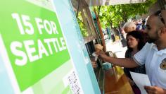 People celebrate with ice cream at Seattle City Hall after a Seattle City Council meeting in which the council voted on raising the minimum wage to $15.00 per hour in Seattle, Washington June 2, 2014. REUTERS/David Ryder 