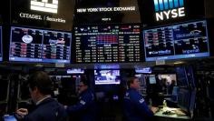 Traders work on the floor at the close of trading at the New York Stock Exchange (NYSE) in Manhattan, New York City, U.S., December 28, 2016. REUTERS/Andrew Kelly 