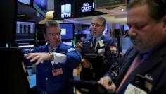 Traders work on the trading floor at the opening of the markets at the New York Stock Exchange (NYSE) in Manhattan, New York City, U.S., February 27, 2017. REUTERS/Andrew Kelly