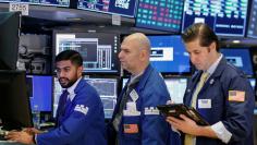 FILE PHOTO - Traders work on the floor of the New York Stock Exchange (NYSE) in New York, U.S., January 26, 2018. REUTERS/Brendan McDermid