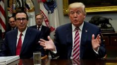 FILE PHOTO - Treasury Secretary Steve Mnuchin listens as U.S. President Donald Trump hosts a tax reform industry meeting at the White House in Washington, U.S., October 31, 2017.  REUTERS/Kevin Lamarque