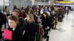 Travelers wait in line at a security checkpoint at La Guardia Airport in New York November 25, 2015. REUTERS/Brendan McDermid 