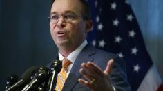 FILE PHOTO: Office of Management and Budget (OMB) Director Mick Mulvaney speaks to the media at the U.S. Consumer Financial Protection Bureau (CFPB), where he began work earlier in the day after being named acting director by U.S. President Donald Trump 