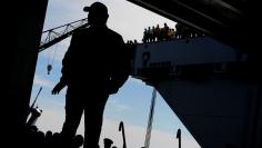 FILE PHOTO: U.S. President Donald Trump takes the stage in the flight hangar to deliver remarks aboard the pre-commissioned U.S. Navy aircraft carrier Gerald R. Ford at Huntington Ingalls Newport News Shipbuilding facilities in Newport News, Virginia, U.