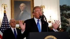 FILE PHOTO: U.S. Vice President Mike Pence listens as U.S. President Donald Trump announces that the United States recognizes Jerusalem as the capital of Israel and will move its embassy there, during an address from the White House in Washington, U.S., 