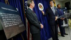 Citizens for Responsibility and Ethics in Washington (CREW) Chairman Norman Eisen (C) joins Maryland Attorney General Brian Frosh (L) and District of Columbia Attorney General Karl Racine as they hold a news conference to announce their lawsuit against U