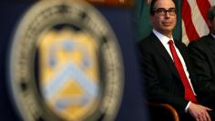 FILE PHOTO: U.S. Secretary of the Treasury Steven Mnuchin sits after swearing-in Joseph M. Otting as Comptroller of the Currency in Washington, U.S., November 27, 2017.   REUTERS/Joshua Roberts