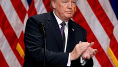 FILE PHOTO: U.S. President Donald Trump claps after delivering remarks regarding the Administration's National Security Strategy at the Ronald Reagan Building and International Trade Center in Washington D.C., U.S., December 18, 2017. REUTERS/Joshua Robe