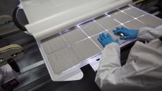 Production operator checks a panel at the SolarWorld solar panel factory in Hillsboro