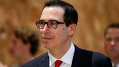 Treasury Secretary Steven Mnuchin walks through the lobby of Trump Tower in New York City, U.S., August 15, 2017. REUTERS/Brendan McDermid 