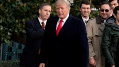 U.S. President Donald Trump looks at  reporters on South Lawn of the White House upon his return in Washington from Pittsburgh, U.S., January 18, 2018. REUTERS/Yuri Gripas