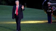 U.S. President Donald Trump waves as walks on the South Lawn of the White House upon his return to Washington, U.S., from the G20 Summit in Hamburg, July 8, 2017. REUTERS/Yuri Gripas