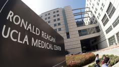 People walk past the entrance to the Ronald Reagan UCLA Medical Center in Los Angeles, California February 19, 2015.  REUTERS/Jonathan Alcorn