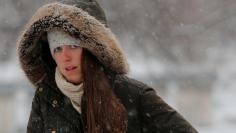 A woman walks through Boston Common during a winter snow storm in Boston, Massachusetts, U.S., January 17, 2018.   REUTERS/Brian Snyder