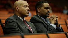 FILE PHOTO: Charlottesville Chief of Police Al Thomas (L) and Charlottesville City Manager Maurice Jones listen to speakers during a public forum hosted by the Department of Justice Community Relations Service after a rally by far-right demonstrators led