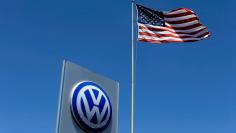 FILE PHOTO: A U.S. flag flutters in the wind above a Volkswagen dealership in Carlsbad, California, U.S. on May 2, 2016.  REUTERS/Mike Blake/File Photo