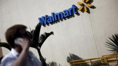 FILE PHOTO -  A man talks on his mobile phone in front of a Wal-Mart store in Sao Paulo, Brazil, February 16, 2016.  REUTERS/Nacho Doce 