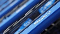 Shopping carts are seen outside a new Walmart Express store in Chicago July 26, 2011.  REUTERS/John Gress