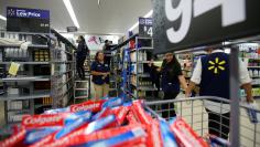 FILE PHOTO: Workers prepare their store for customers at a newly built Walmart Super Center in Compton