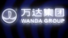 FILE PHOTO: A sign of Dalian Wanda Group in China glows during an event announcing strategic partnership between Wanda Group and FIFA in Beijing, China March 21, 2016. REUTERS/Damir Sagolj/File Photo