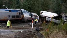 FILE PHOTO: Investigators begin analysis at the scene where an Amtrak passenger train derailed on a bridge over interstate highway I-5  in DuPont, Washington, U.S. on December 18, 2017. REUTERS/Steve Dipaola/File Photo