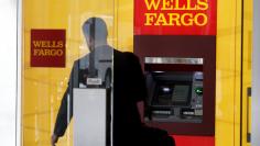 A man walks by a bank machine at the Wells Fargo & Co. bank in downtown Denver, Colorado, U.S. April 13, 2016.   REUTERS/Rick Wilking/File Photo